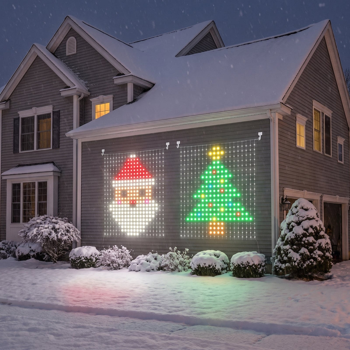 Two Cheriemood curtains side by side on the side wall of a snowy house, one showing Santa and one a Christmas tree